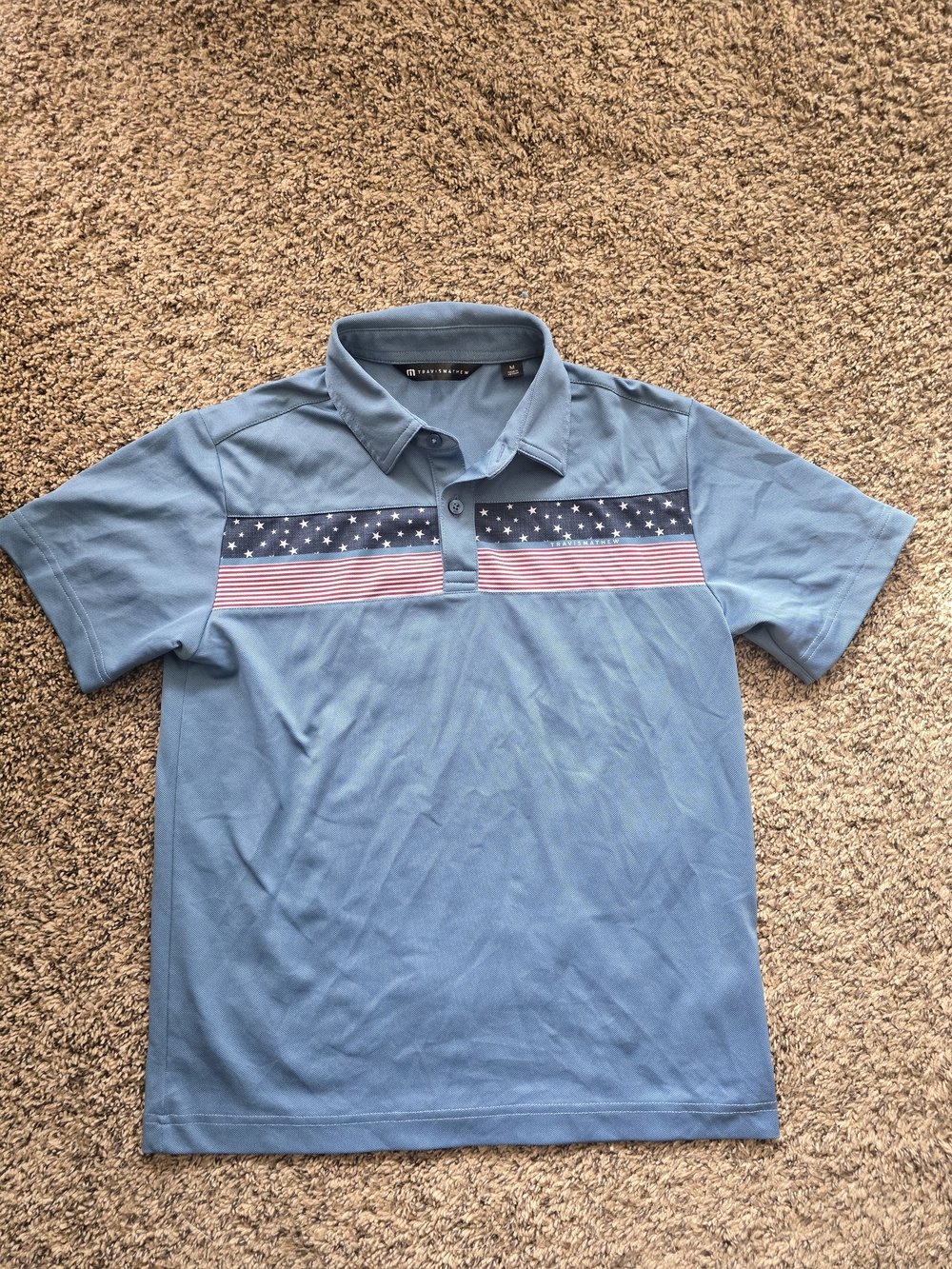 Travis Mathew Light Blue Polo with Navy and Red Flag Stripe